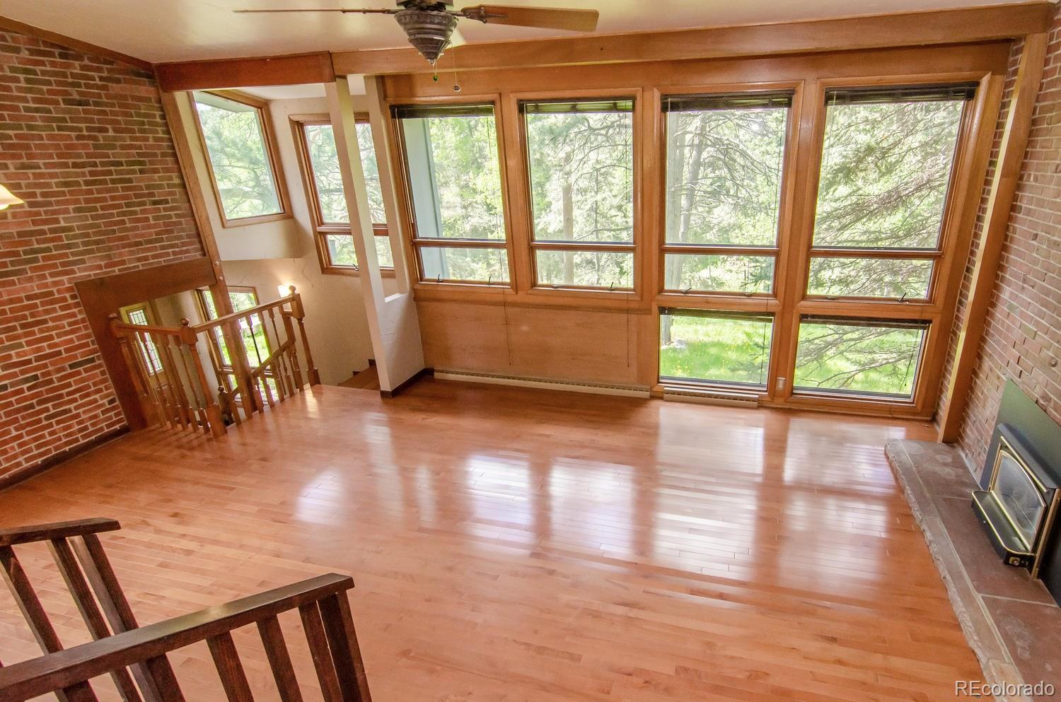 31463 Upper Bear Creek Road Evergreen, CO 80439 - Photo 8 of 23 a view of an empty room with wooden floor and a window