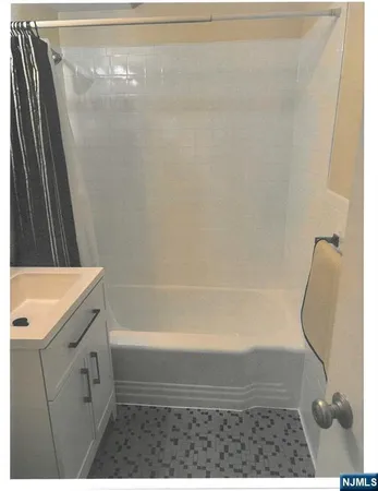 a bathroom with a shower and a sink
