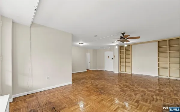 a view of an empty room with a ceiling fan