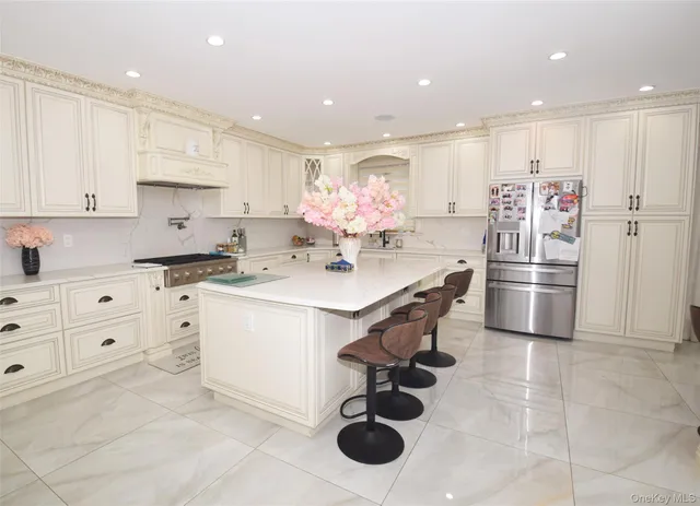 a kitchen with stainless steel appliances a refrigerator sink and cabinets