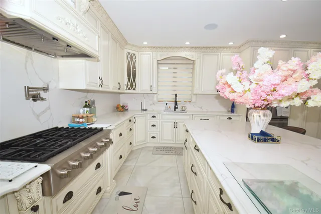 a kitchen with granite countertop a sink stove and cabinets