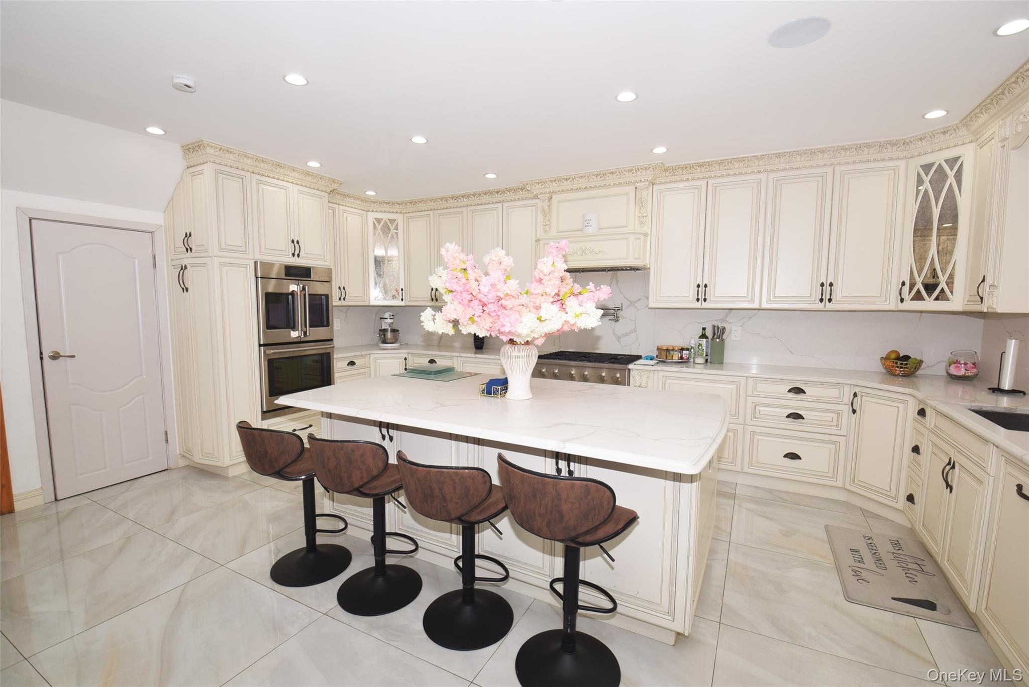 1-10 82nd Avenue Queens, NY 11415 - Photo 14 of 50 a kitchen with stainless steel appliances kitchen island granite countertop a sink and cabinets