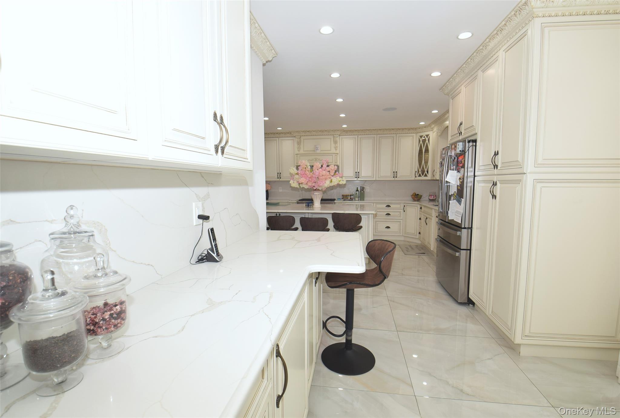 1-10 82nd Avenue Queens, NY 11415 - Photo 15 of 50 a kitchen with a sink and chairs
