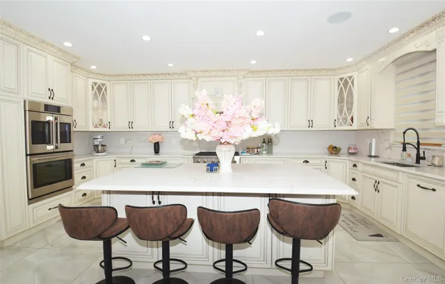 a kitchen with stainless steel appliances kitchen island granite countertop a sink and cabinets