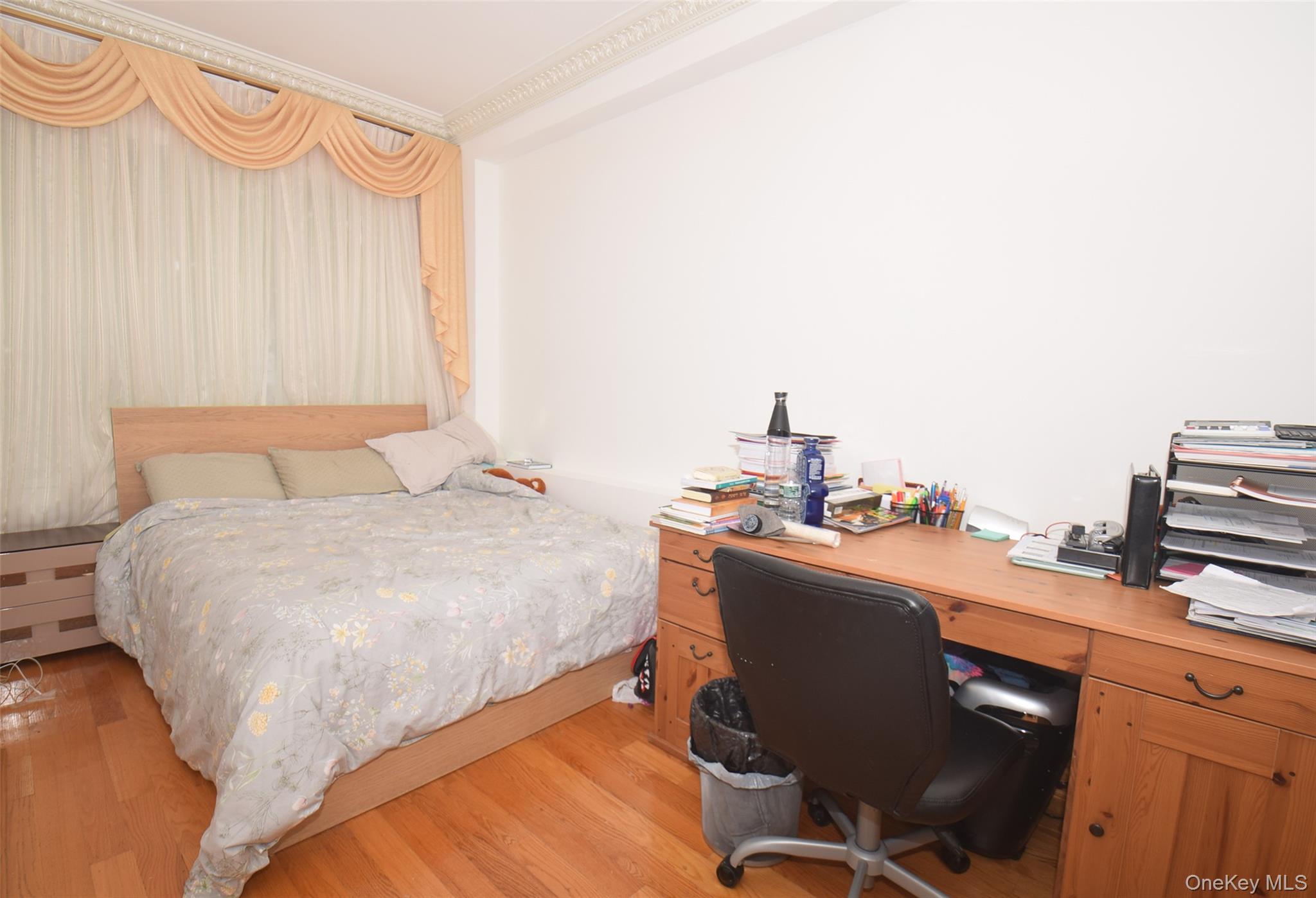 1-10 82nd Avenue Queens, NY 11415 - Photo 20 of 50 a bedroom with a bed and a chair