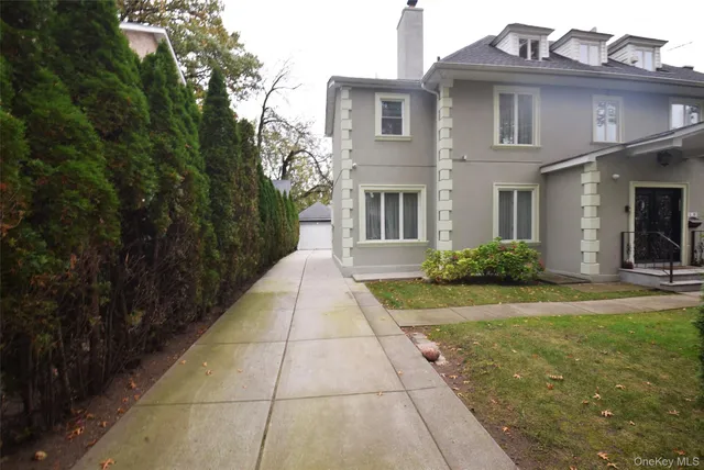 a view of a brick house with many windows