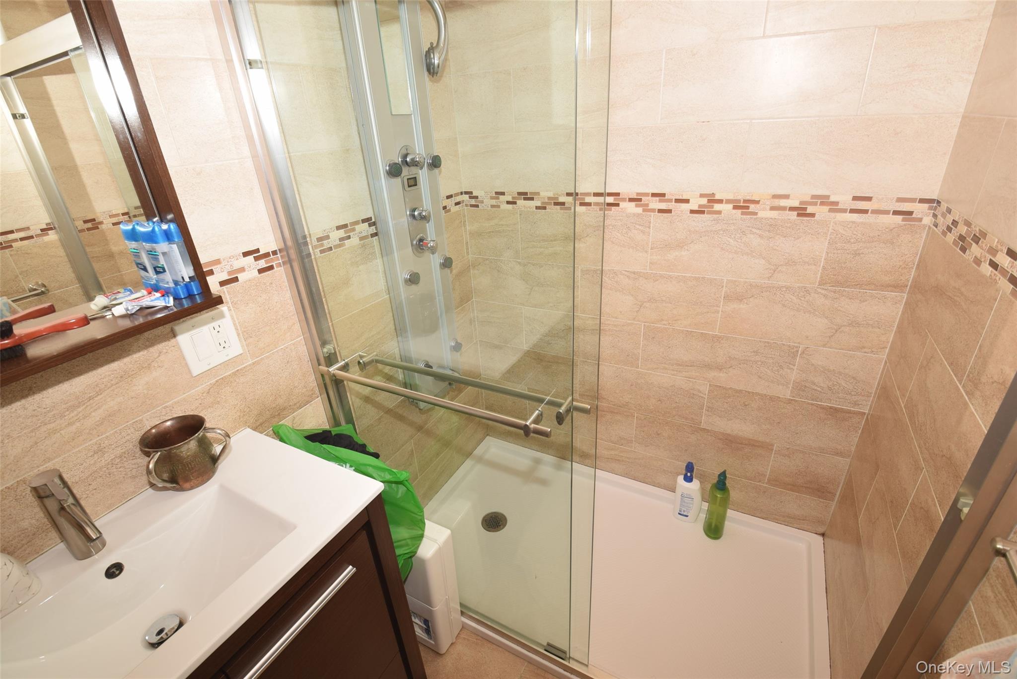 1-10 82nd Avenue Queens, NY 11415 - Photo 22 of 50 a bathroom with a sink and a mirror