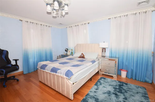 a bed room with a bed and a chair