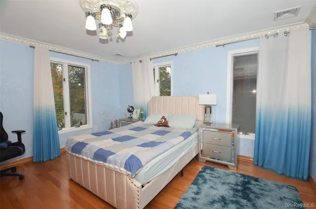 a bedroom with a bed and a chandelier