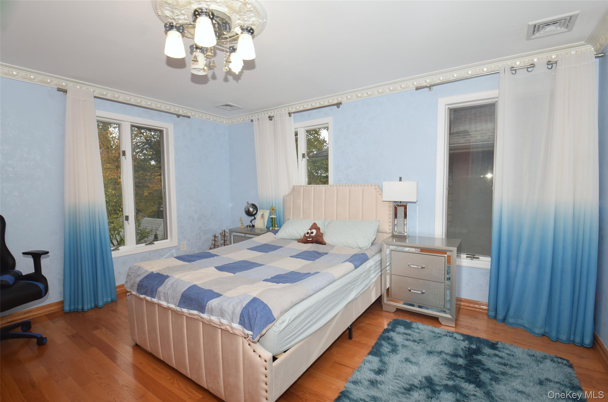 1-10 82nd Avenue Queens, NY 11415 - Photo 27 of 50 a bedroom with a bed and a chandelier