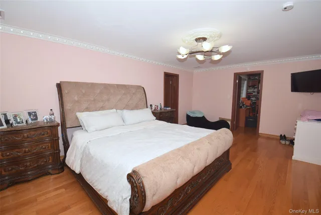 a bedroom with bed and a chandelier