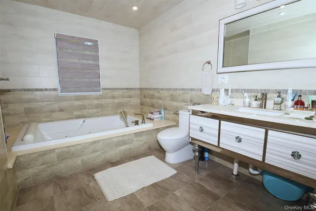 a spacious bathroom with a bathtub sink and toilet