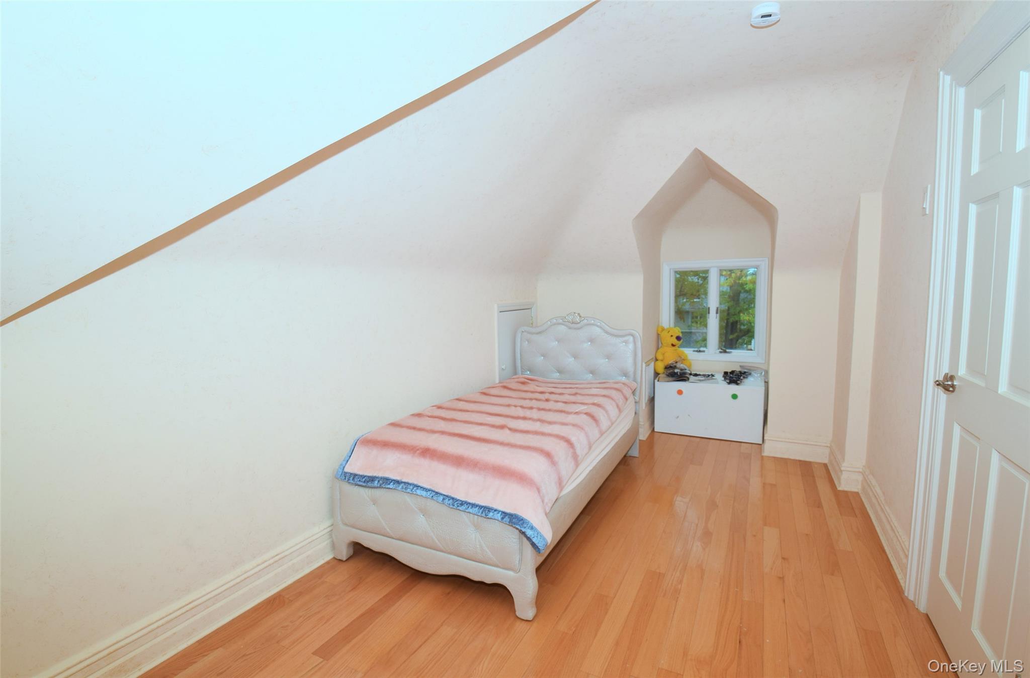 1-10 82nd Avenue Queens, NY 11415 - Photo 37 of 50 a bedroom with a bed and a potted plant