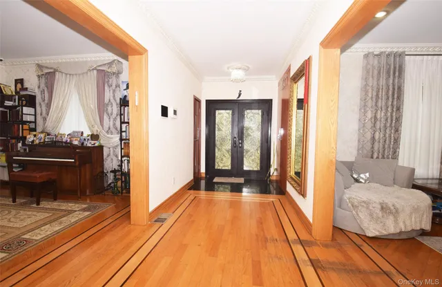 a spacious bedroom with a bed and a chandelier
