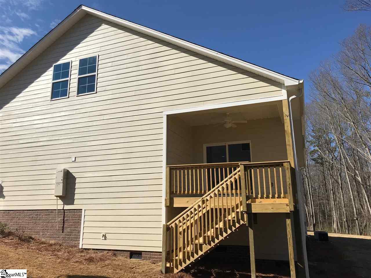 The covered side/back porch with a ceiling fan and light.