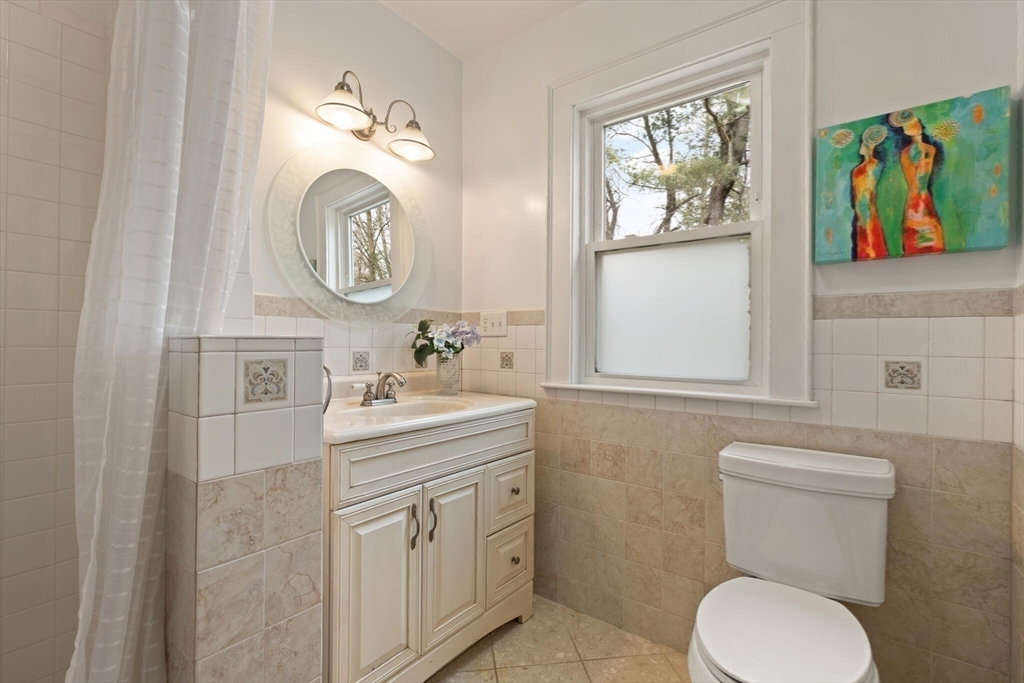 59 Reed Street Lexington, MA 02421 - Photo 14 of 32 a bathroom with a toilet a sink and a mirror