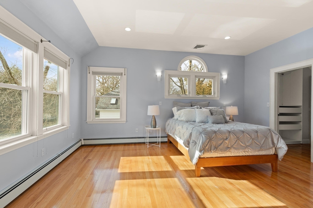 59 Reed Street Lexington, MA 02421 - Photo 16 of 32 a spacious bedroom with a bed and wooden floor