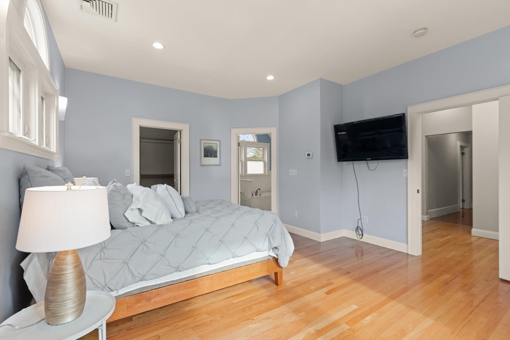 59 Reed Street Lexington, MA 02421 - Photo 17 of 32 a bedroom with a large bed and a flat screen tv