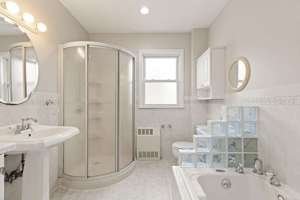 59 Reed Street Lexington, MA 02421 - Photo 22 of 32 a bathroom with a double vanity sink mirror and bathtub