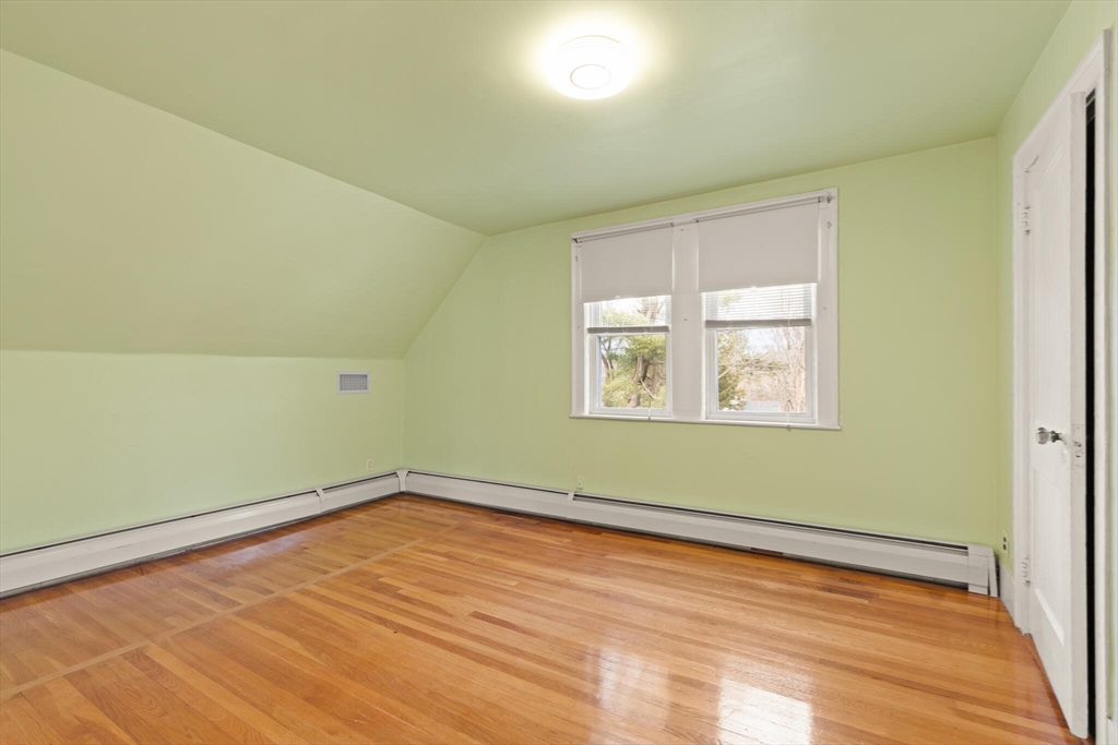 59 Reed Street Lexington, MA 02421 - Photo 25 of 32 an empty room with wooden floor and windows