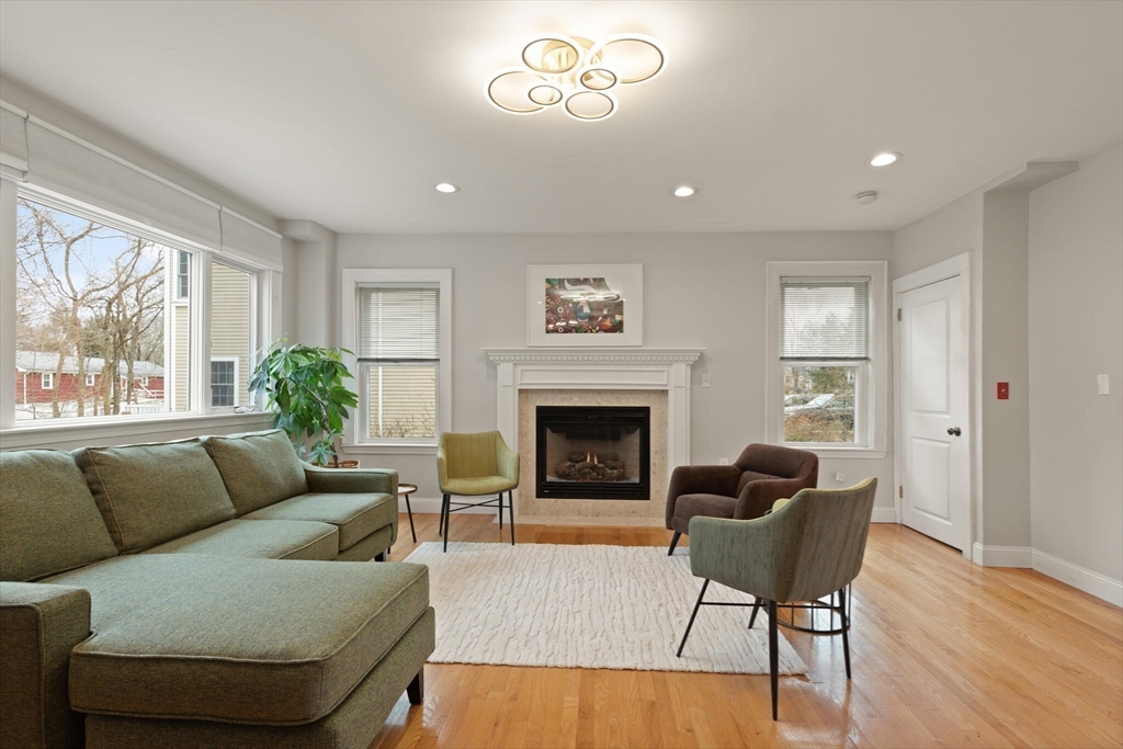 59 Reed Street Lexington, MA 02421 - Photo 7 of 32 a living room with furniture and a fireplace