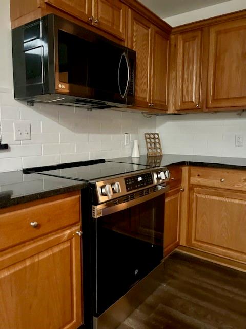 478 Crumbley Road McDonough, GA 30252 - Photo 5 of 7 a kitchen with granite countertop a stove top oven microwave and cabinets