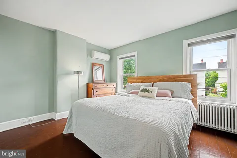 a bedroom with a bed and window