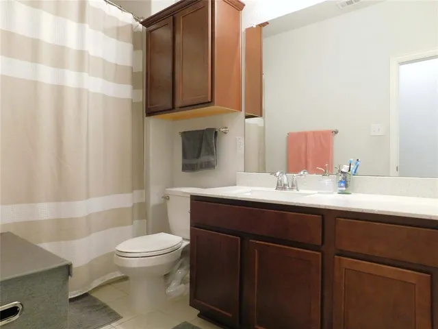 a bedroom with a bed and cabinet