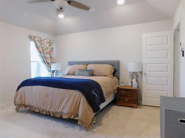 a bedroom with bed and window