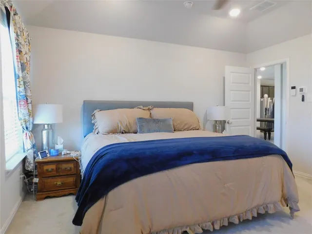 a bedroom with a bed and a dresser