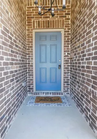 a view of a door with brick walls