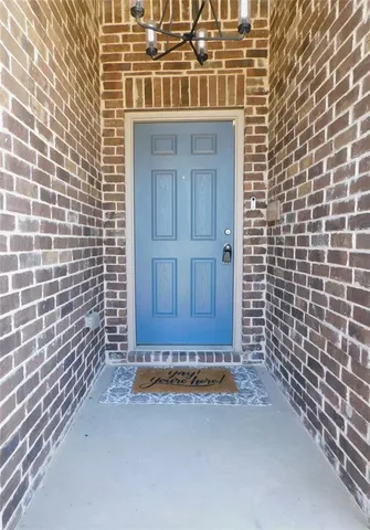 a view of a door with brick walls