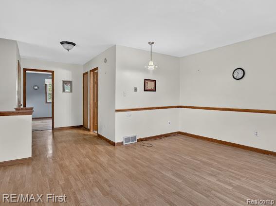 56375 Bates Road New Baltimore, MI 48051 - Photo 26 of 35 Wood-finish flooring throughout, complemented by a chair rail molding