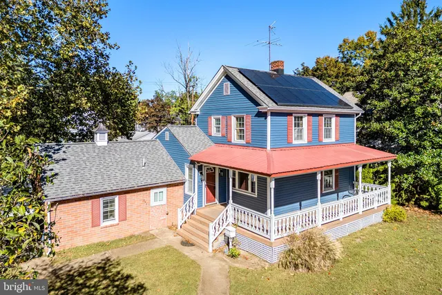 a view of a house with a yard balcony and furniture