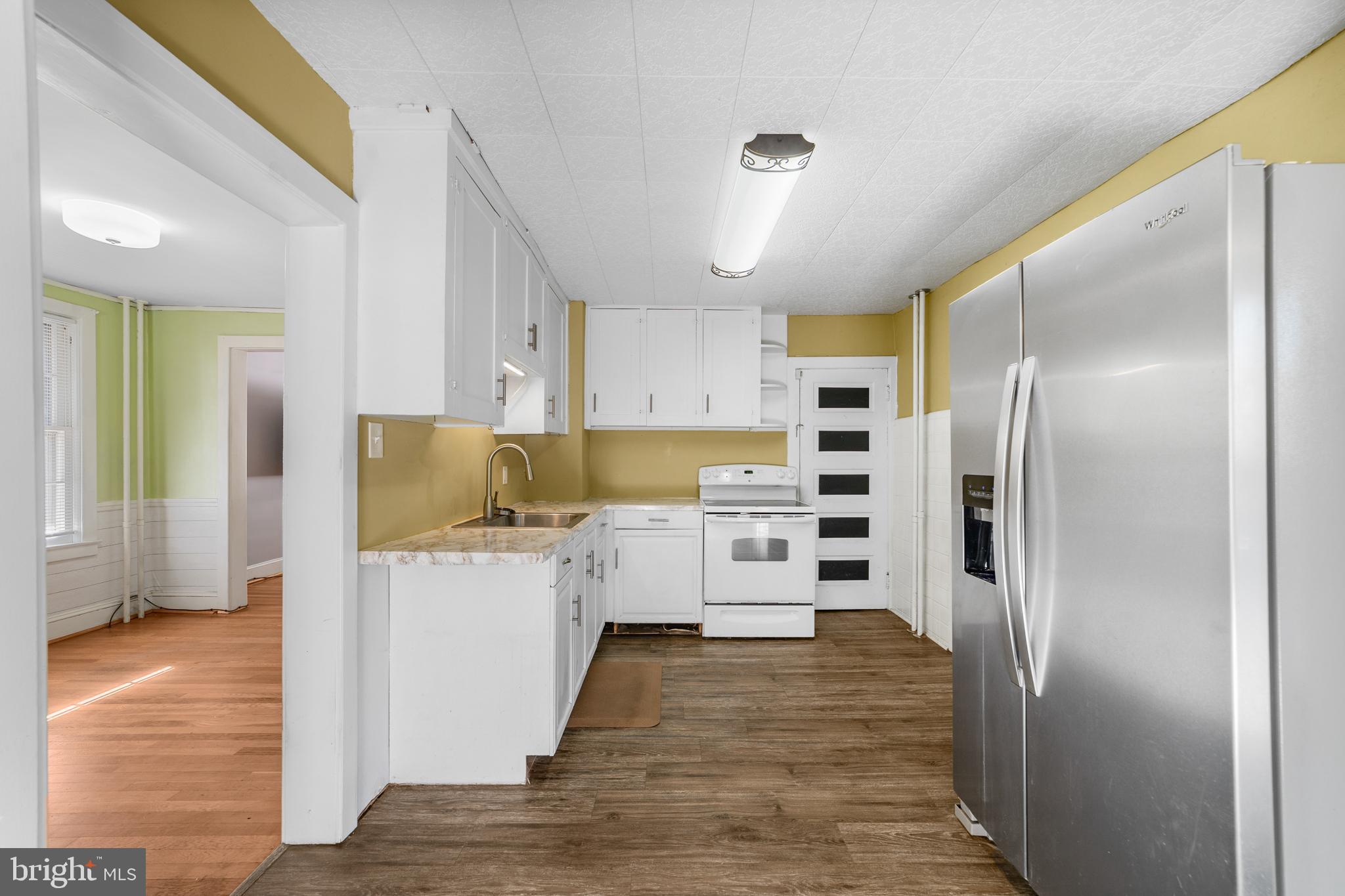 292 C Street Carneys Point, NJ 08069 - Photo 11 of 37 a kitchen with a refrigerator and a wooden floor