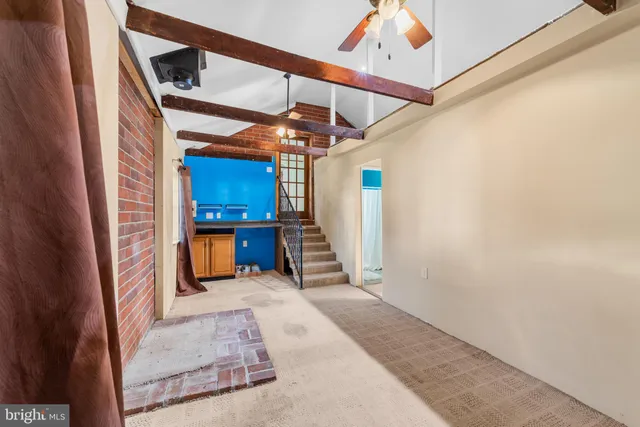 a view of a hallway with wooden floors and stairs