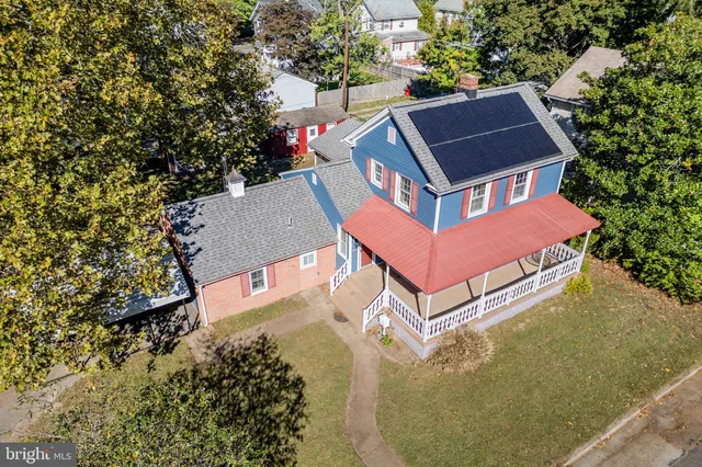 an aerial view of a house with a yard and trees