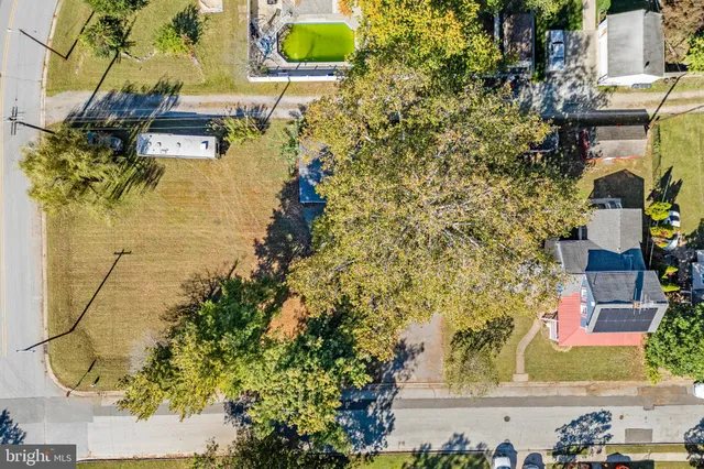 a aerial view of a residential apartment building with a yard