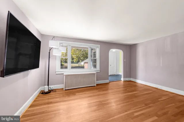 a view of a livingroom with wooden floor and a flat screen tv