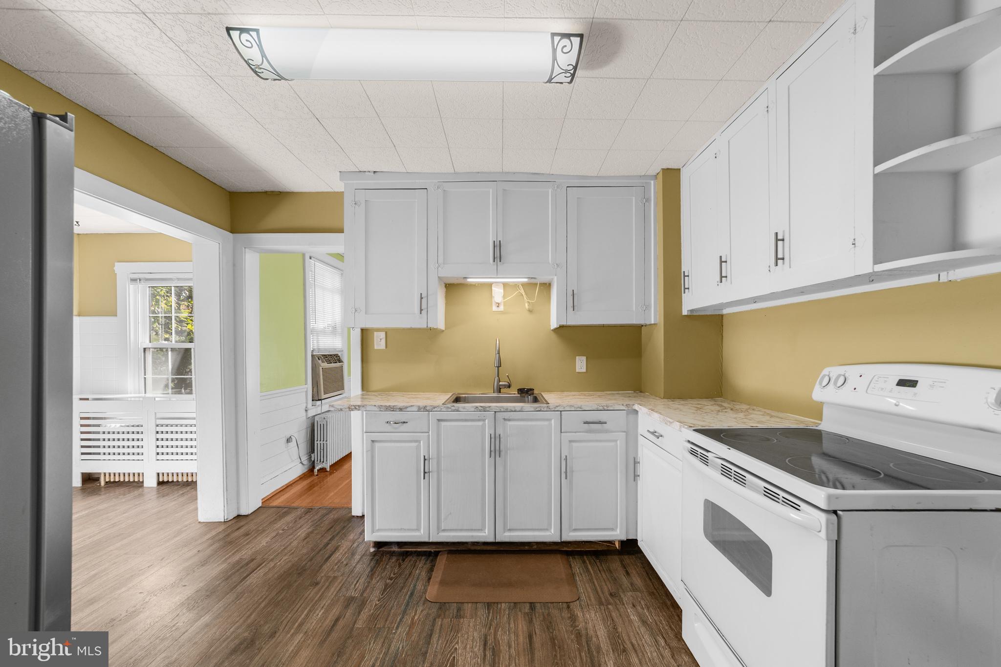 292 C Street Carneys Point, NJ 08069 - Photo 10 of 37 a kitchen with granite countertop a white stove top oven and cabinets