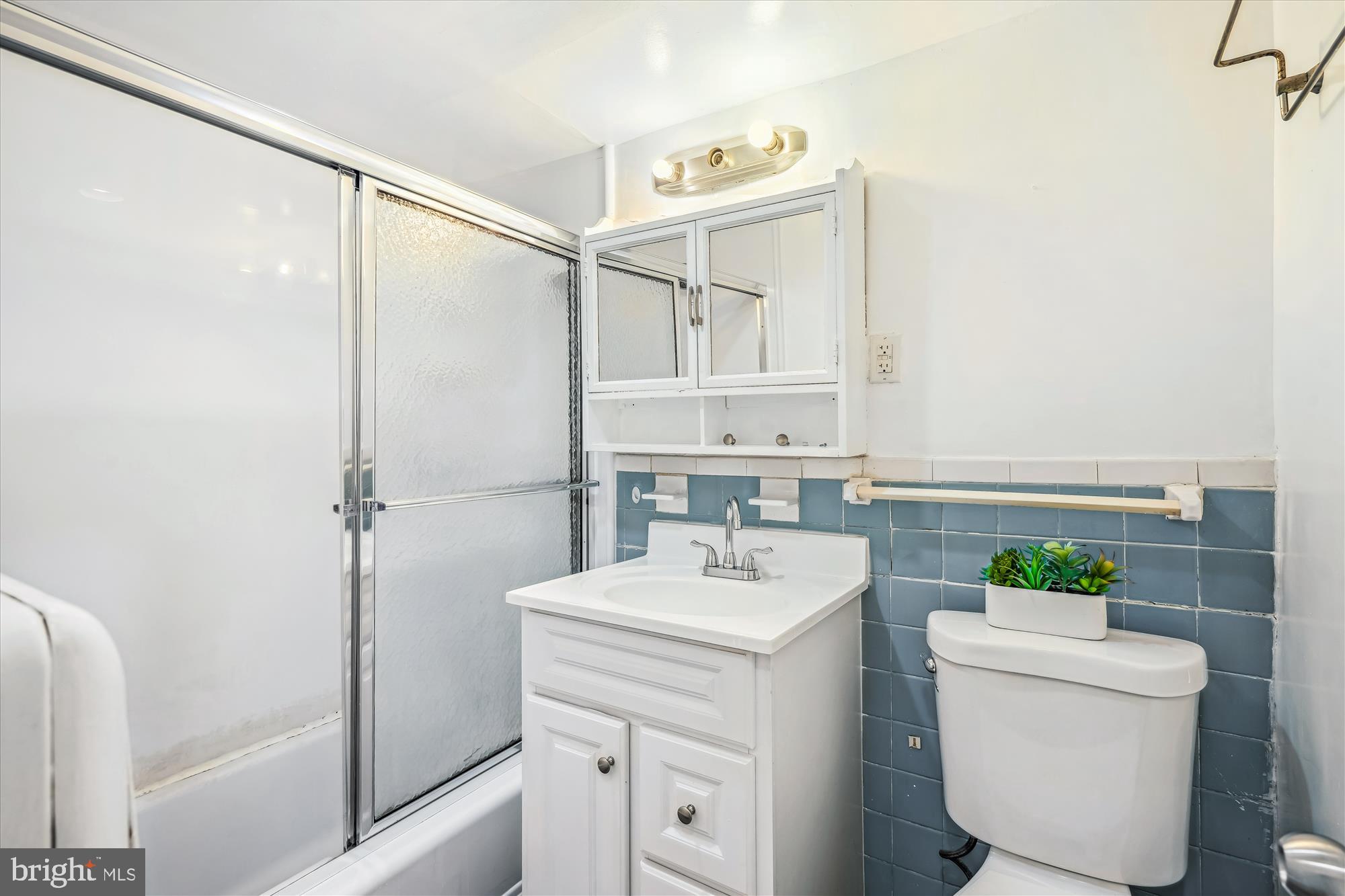 9274 Adelphi Road, Unit 202 Hyattsville, MD 20783 - Photo 13 of 25 a bathroom with a sink toilet and shower