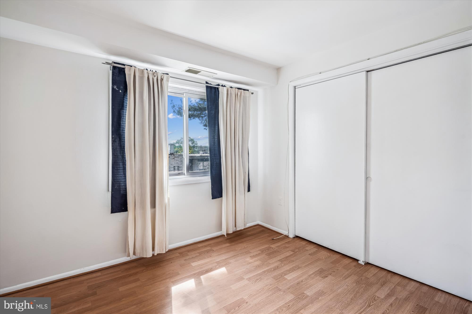 9274 Adelphi Road, Unit 202 Hyattsville, MD 20783 - Photo 15 of 25 an empty room with wooden floor and entrance