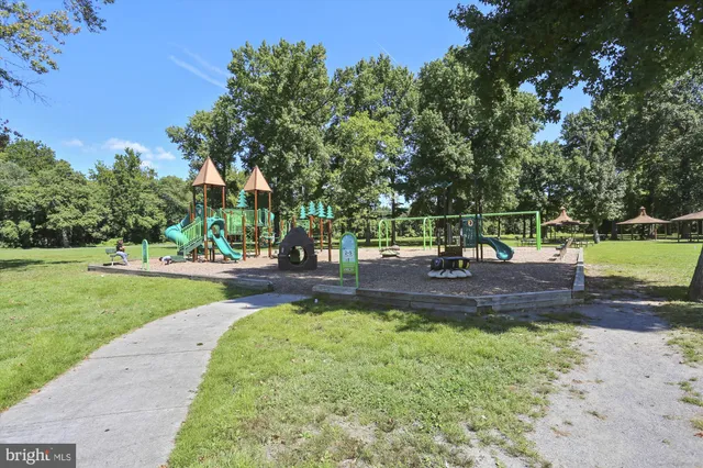 a view of park with slide and trees