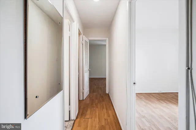a view of a hallway with wooden floor