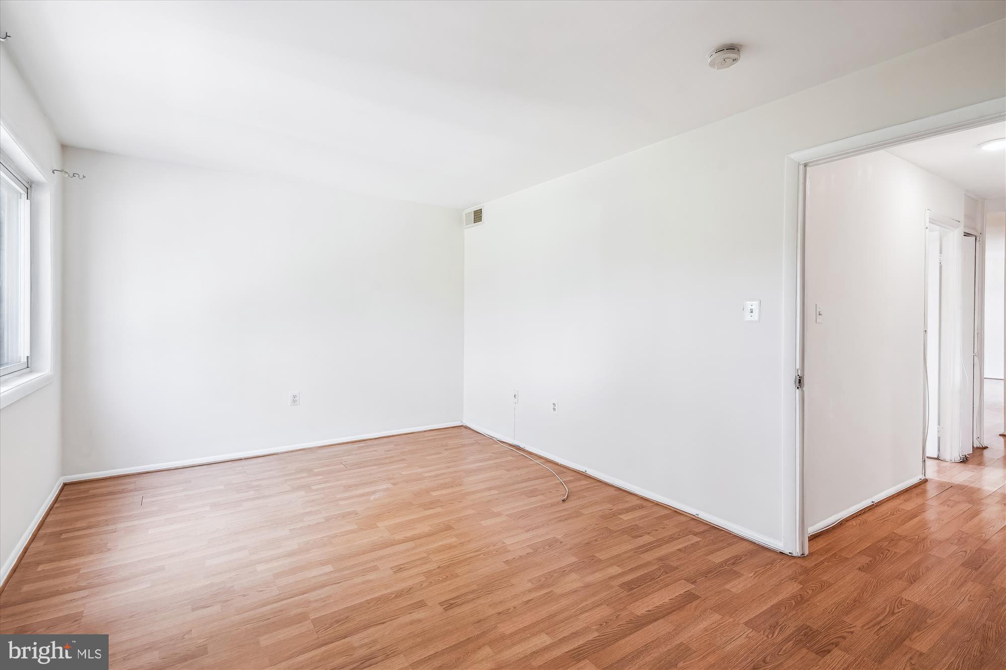 9274 Adelphi Road, Unit 202 Hyattsville, MD 20783 - Photo 10 of 25 a view of an empty room with wooden floor