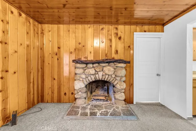 a living room with a fireplace furniture and a wooden floor