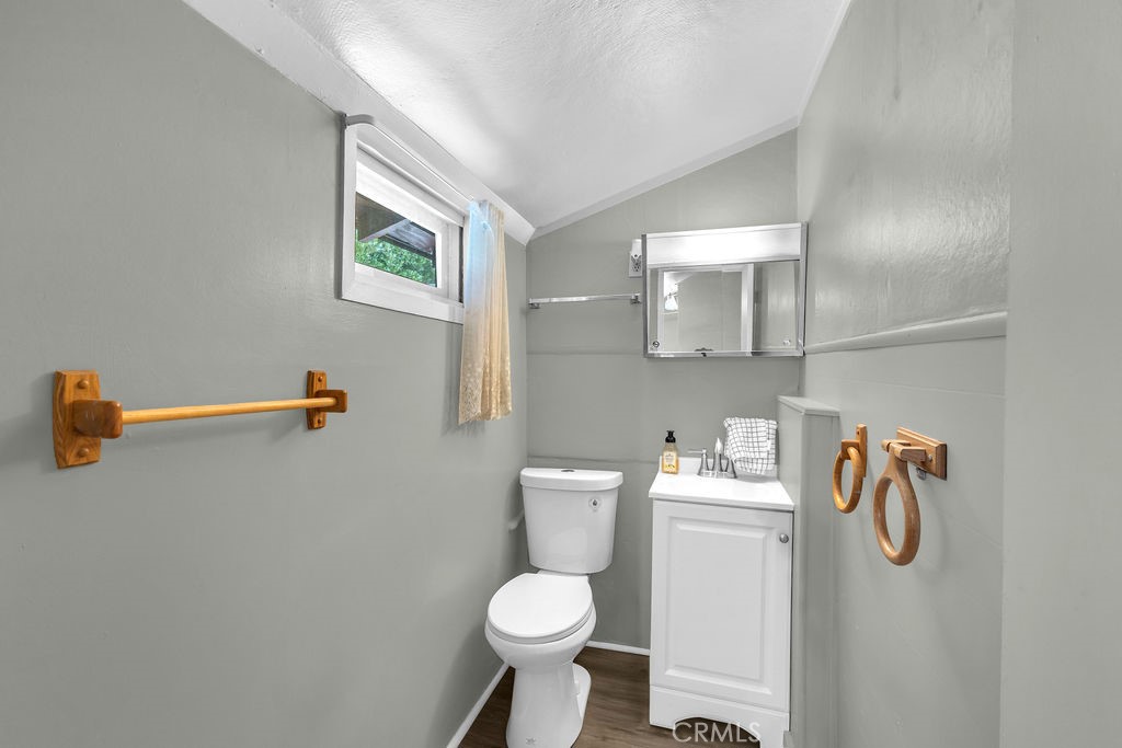 53705 Country Club Drive Idyllwild, CA 92549 - Photo 19 of 26 a white toilet sitting next to a bathroom sink