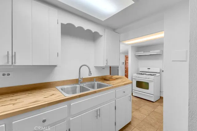 a kitchen with a sink cabinets and stainless steel appliances