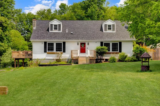 a front view of house with yard and green space