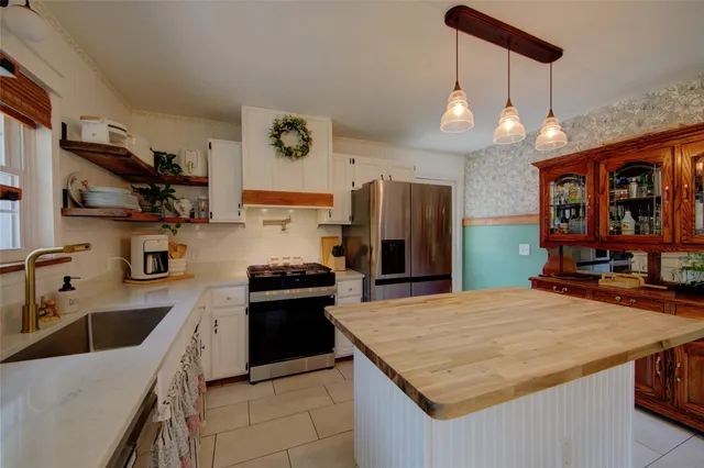a kitchen with granite countertop a sink appliances and cabinets